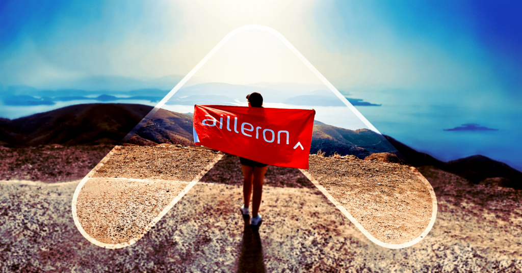 person with ailleron flag on the mountain