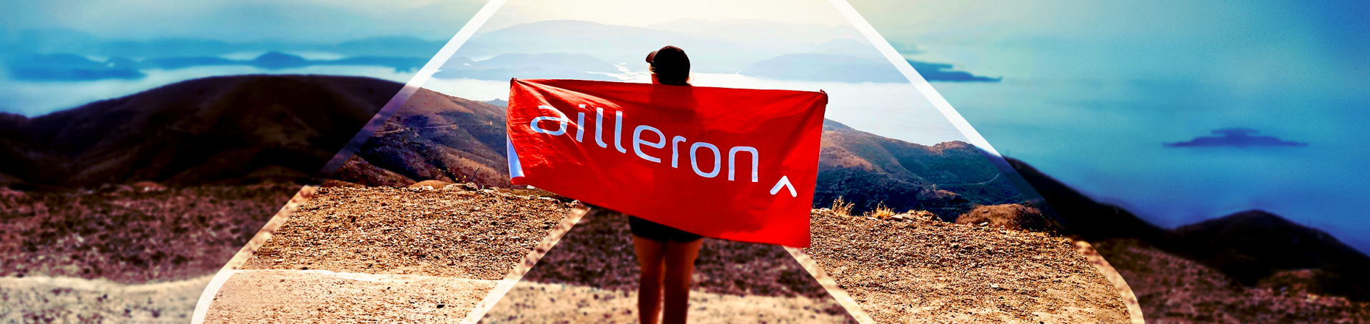 person with ailleron flag on the mountain